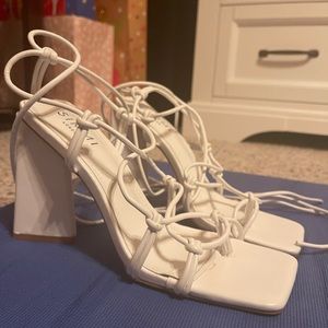 White open toe lace up heels and it was worn one time.